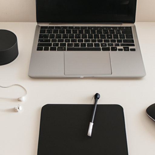 Neutral-toned desk setup featuring the space black macbook pro centered with various office supplies